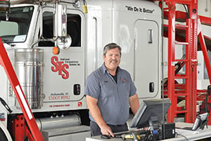 Man standing by STS truck